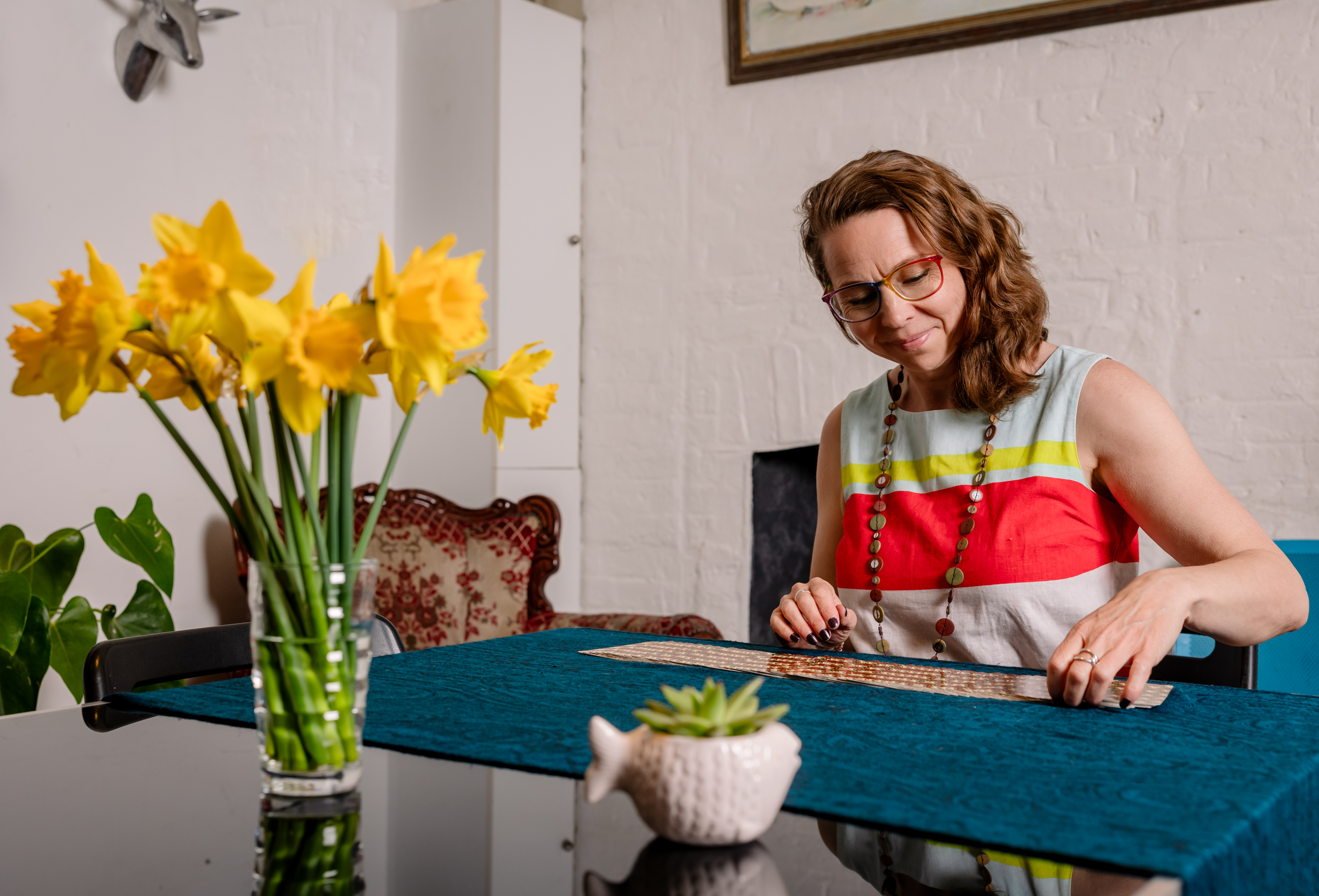 Image of Sam Pope smiling and looking at tarot cards